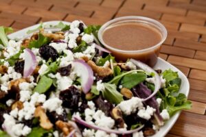 CHERRY WALNUT SALAD ~ Fresh Mixed Greens, Red Onions, Dried Cherries, Walnuts and Fresh Goat Cheese. Served with our delicious, homemade Raspberry Vinaigrette Dressing!